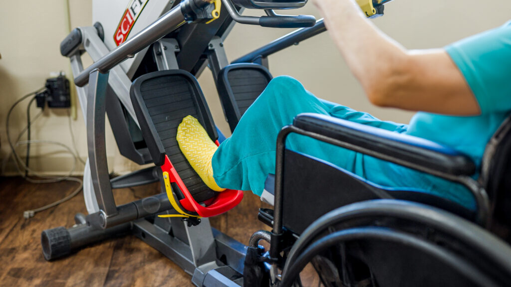 A short term care resident at a skilled nursing facility using exercise equipment